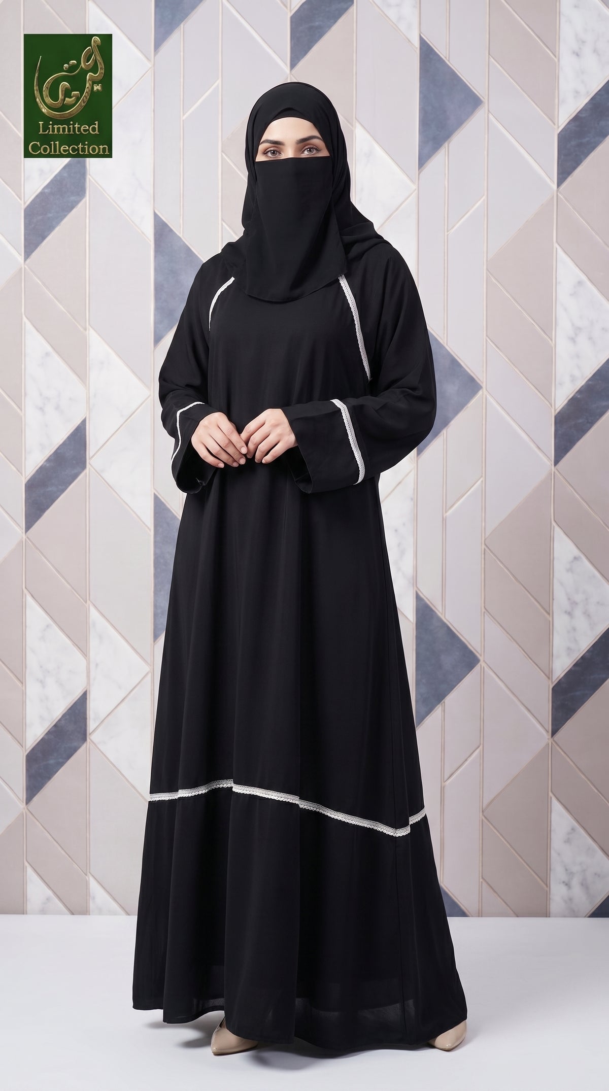 A woman wearing a long black abaya with white lacework details and a matching black hijab, standing in front of a geometric patterned wall. The logo 'Limited Collection' is visible in the top-left corner.