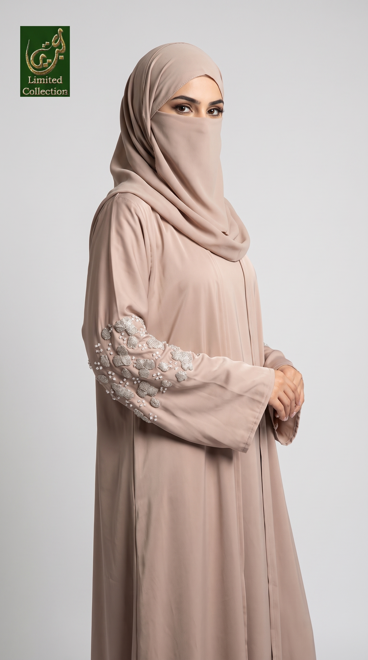 A woman wearing a modest pink 3d cutdana embroidered abaya and matching hijab with floral embroidery on the sleeve, photographed against a light gray studio background. A 'Abayat Limited Collection' logo appears in the top-left corner.