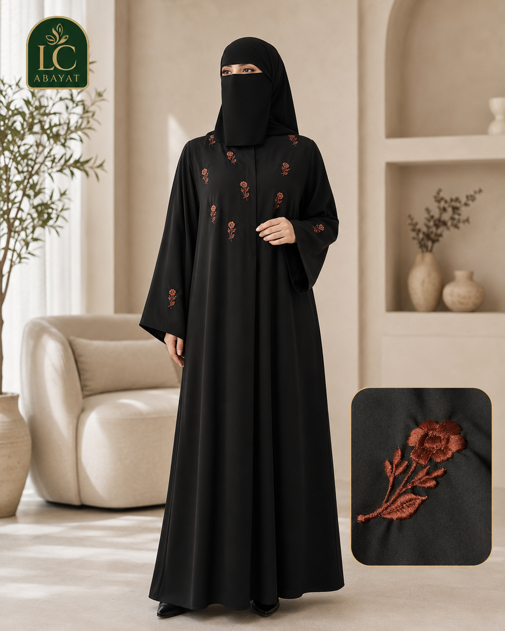 A woman wearing a black full-length abaya with embroidered floral details, standing in a softly lit indoor setting. A close-up inset in the lower right shows the embroidery detail.