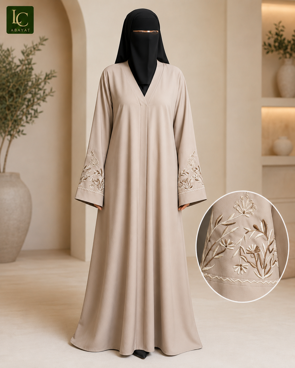 A woman modeling a long beige abaya with embroidered details on the sleeves, paired with a black face veil, in a warm neutral interior setting. An inset circle shows a close-up of the sleeve embroidery.
