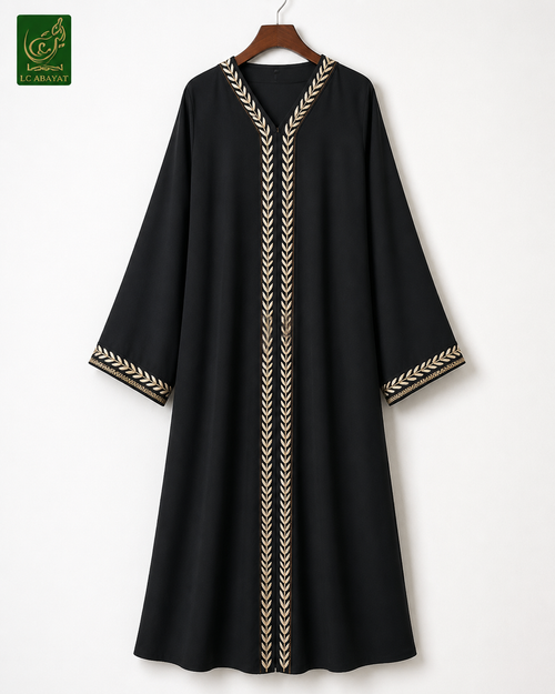 A black long-sleeve abaya dress with gold chevron leaf embroidery on the neckline, front, and cuffs, hanging on a wooden hanger against a plain white wall.