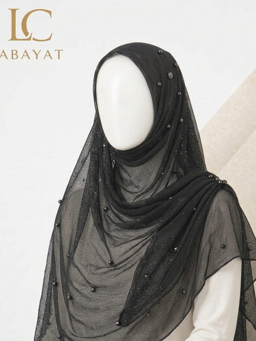 A black sheer mesh hijab with small bead embellishments, draped on a white mannequin torso. The brand logo 'LC ABAYAT' is visible in the top left corner.