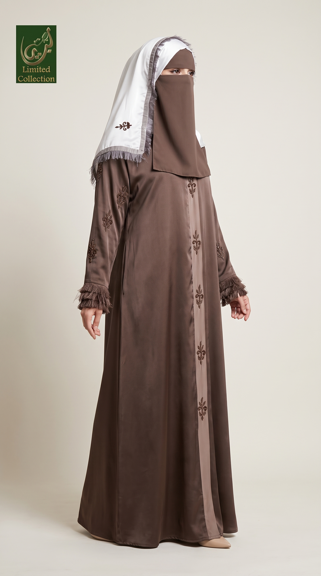 A woman modeling a long brown abaya with matching head covering, shown against a plain light beige studio background. A green 'Limited Collection' logo appears in the top-left corner.