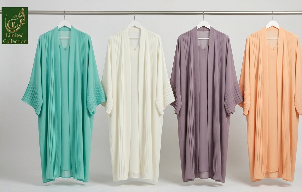 Four lightweight draped Butterfly Kimono Front open Abayas hanging on white hangers against a plain light gray studio background. From left to right, the colors are mint green, white, grey, and peach.