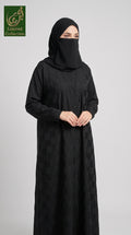 Woman wearing a front-open checkered black jacquard abaya with buttons.