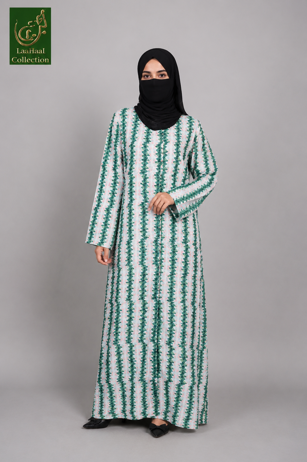 A woman wearing a long-sleeved green and white vertically patterned abaya with a black face covering and black shoes, standing against a solid gray studio background. A 'Limited Collection' logo is visible in the top-left corner.