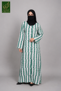 A woman wearing a long-sleeved green and white vertically patterned abaya with a black face covering and black shoes, standing against a solid gray studio background. A 'Limited Collection' logo is visible in the top-left corner.