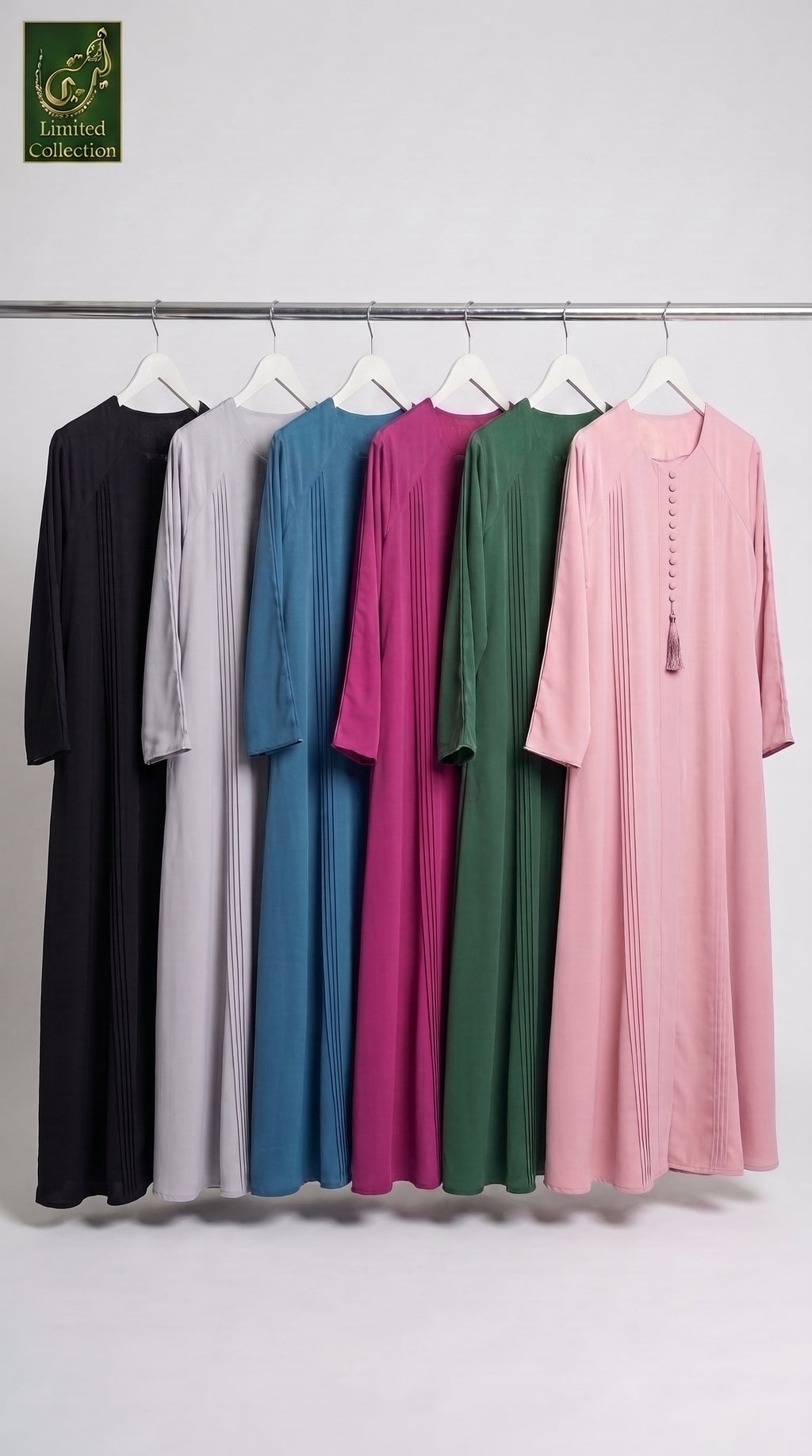 Six long modest Dubai Style Long Flair Pleated Maxi Abaya With Tassel Button in Premium Romantic Nida fabric which are in black, light gray, blue, magenta, green, and pink are hanging on white hangers from a metal rack against a plain light gray wall. A small 'Limited Collection' logo appears in the top-left corner.