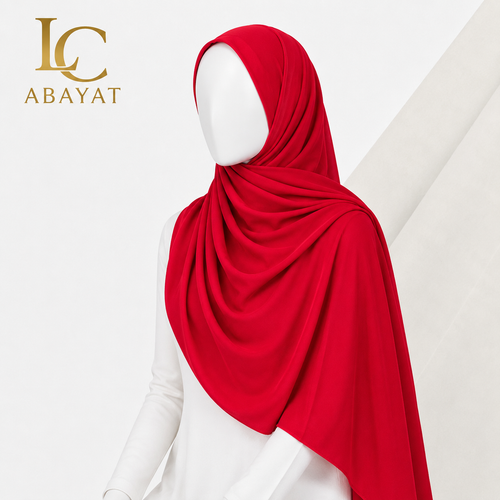 A bright red hijab draped elegantly on a white mannequin torso, with the LC ABAYAT logo in gold in the top-left corner against a clean white background.