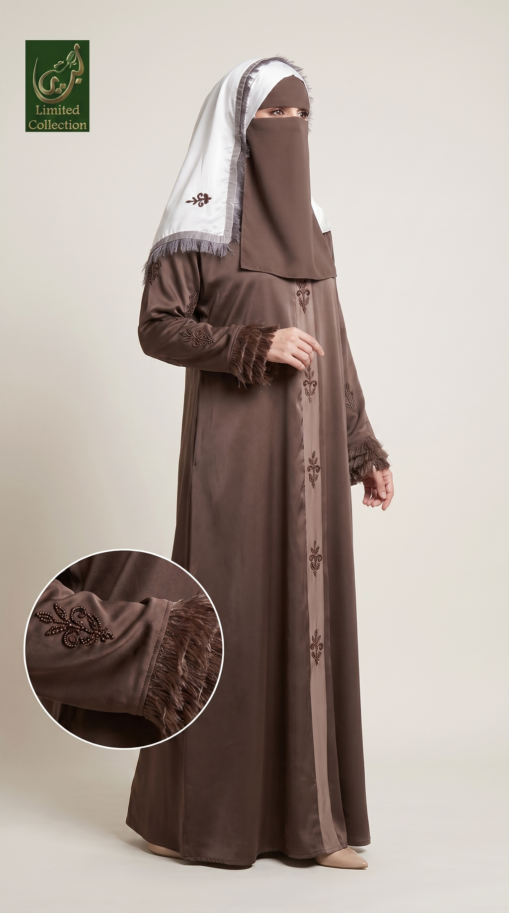 A woman modeling a brown abaya with a matching brown hijab and a white headscarf, shown against a plain beige studio background. A circular inset highlights the embroidered sleeve detail.