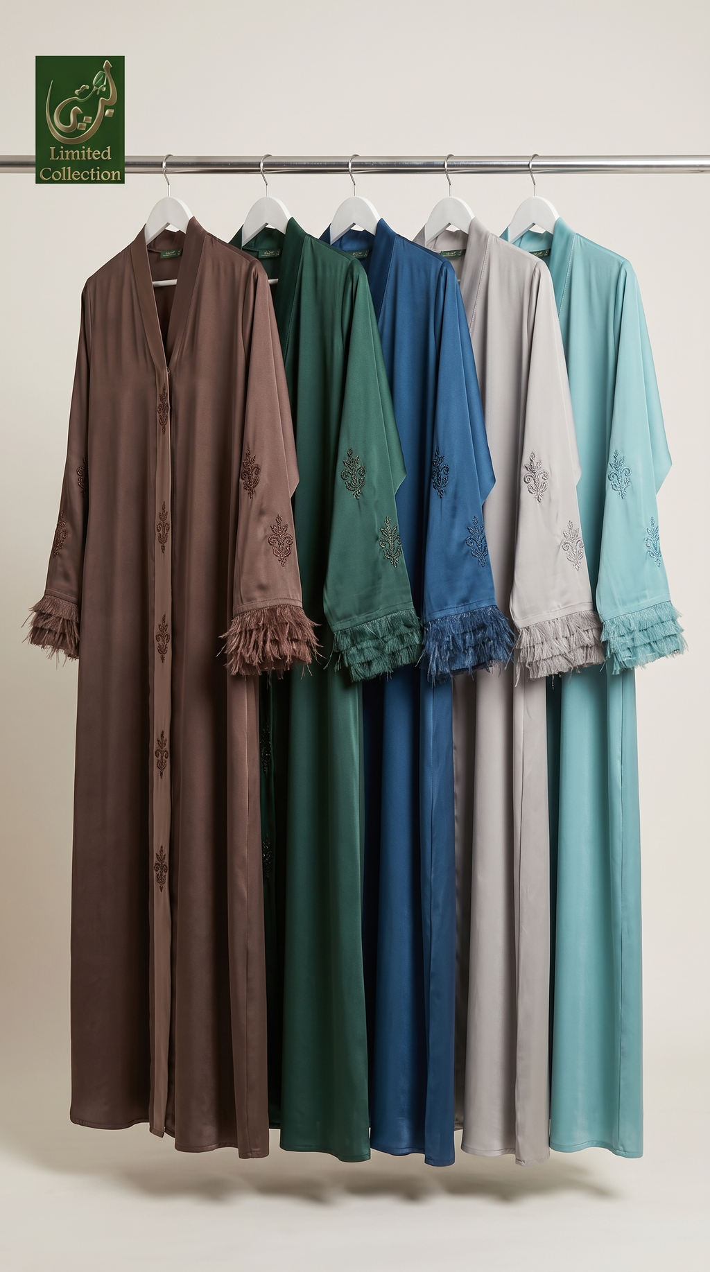 Five long modest garments hanging on a metal rack against a plain light background. The garments are shown in brown, green, blue, light gray, and teal, each with embroidered details and ruffled cuffs.