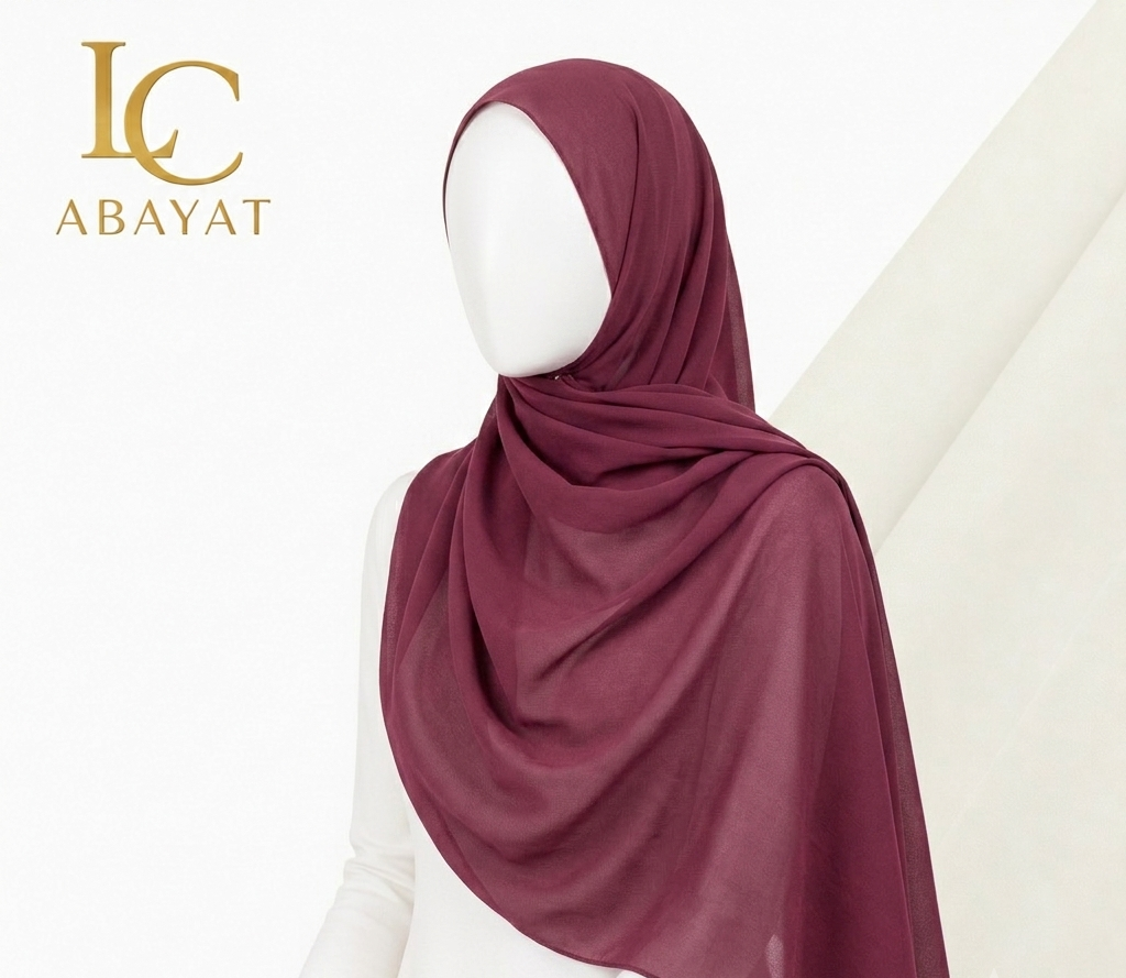 A hijab scarf in a deep burgundy or plum shade, draped on a white mannequin. The logo 'IC ABAYAT' is visible in the top left corner.