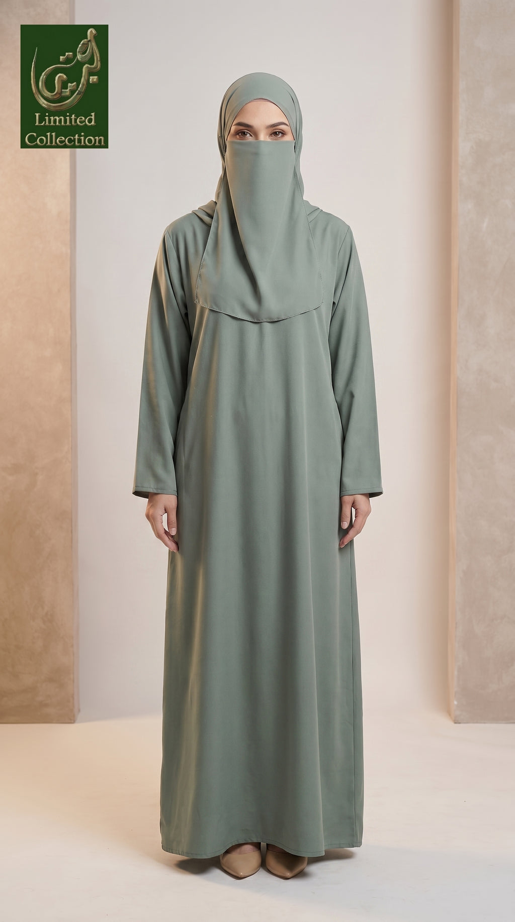 A woman modeling a sage green abaya and matching hijab in a studio setting with beige textured walls. A green 'Limited Collection' logo is visible in the top-left corner.