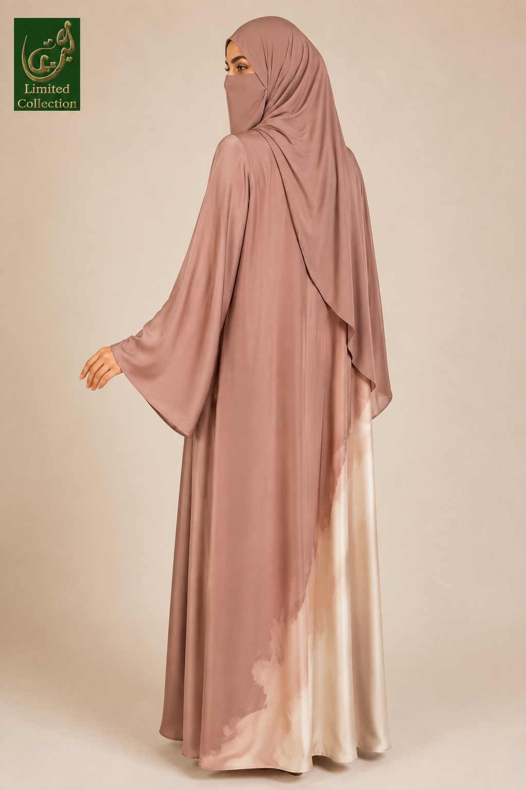 A woman wearing a modest long abaya and matching hijab in a dusty rose color with a satin-like lower hem that fades into a light champagne tone, shown against a plain beige studio background. A green 'Limited Collection' logo appears in the top-left corner.