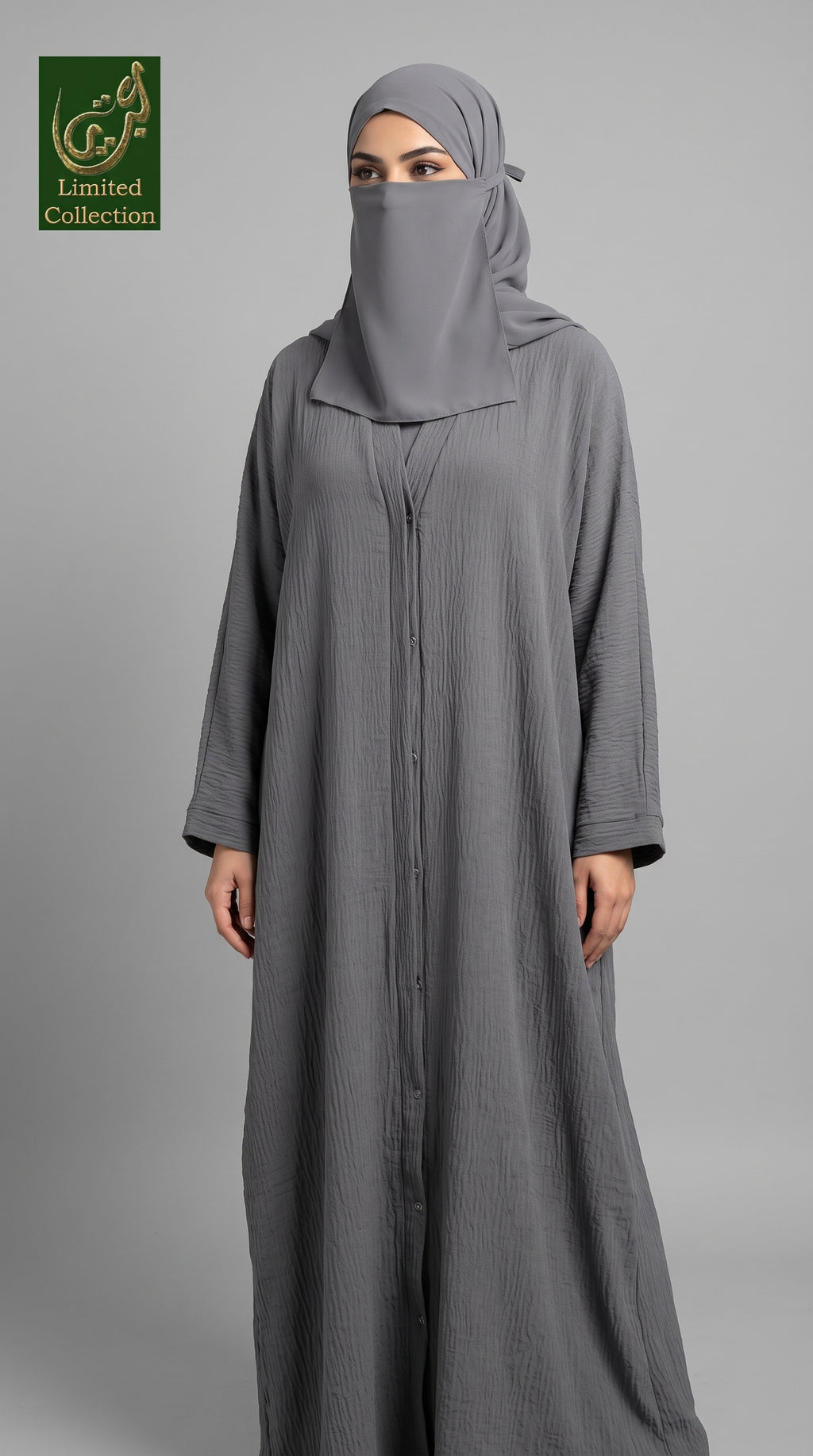 A woman wearing a cey fabric long, loose-fit gray abaya with a front zipper and matching gray hijab, standing against a plain light gray studio background. A small 'Limited Collection' logo appears in the top-left corner.