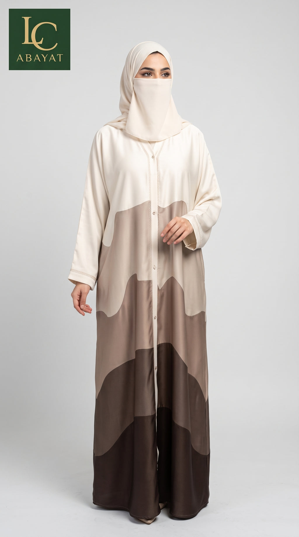 A woman modeling a long, flowing abaya with a matching hijab. The abaya features a color-blocked pattern in cream, beige, taupe, and dark brown.