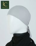 A light gray fabric head covering displayed on a white mannequin head, with a black neck drape underneath. The image includes an LC ABAYAT logo in the top-left corner against a plain light gray background.