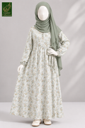 A long-sleeved maxi abaya for kids with a delicate beige and green floral pattern, styled on a mannequin with a sage green hijab. The image is from the 'Limited Collection' line, shown against a neutral gray background with soft shadows.