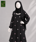 A black long-sleeve modest dress with small pink and white embroidered motifs, shown on a mannequin with a black hijab. A green 'Abayat Limited Collection' logo appears in the top-left corner against a light gray background.