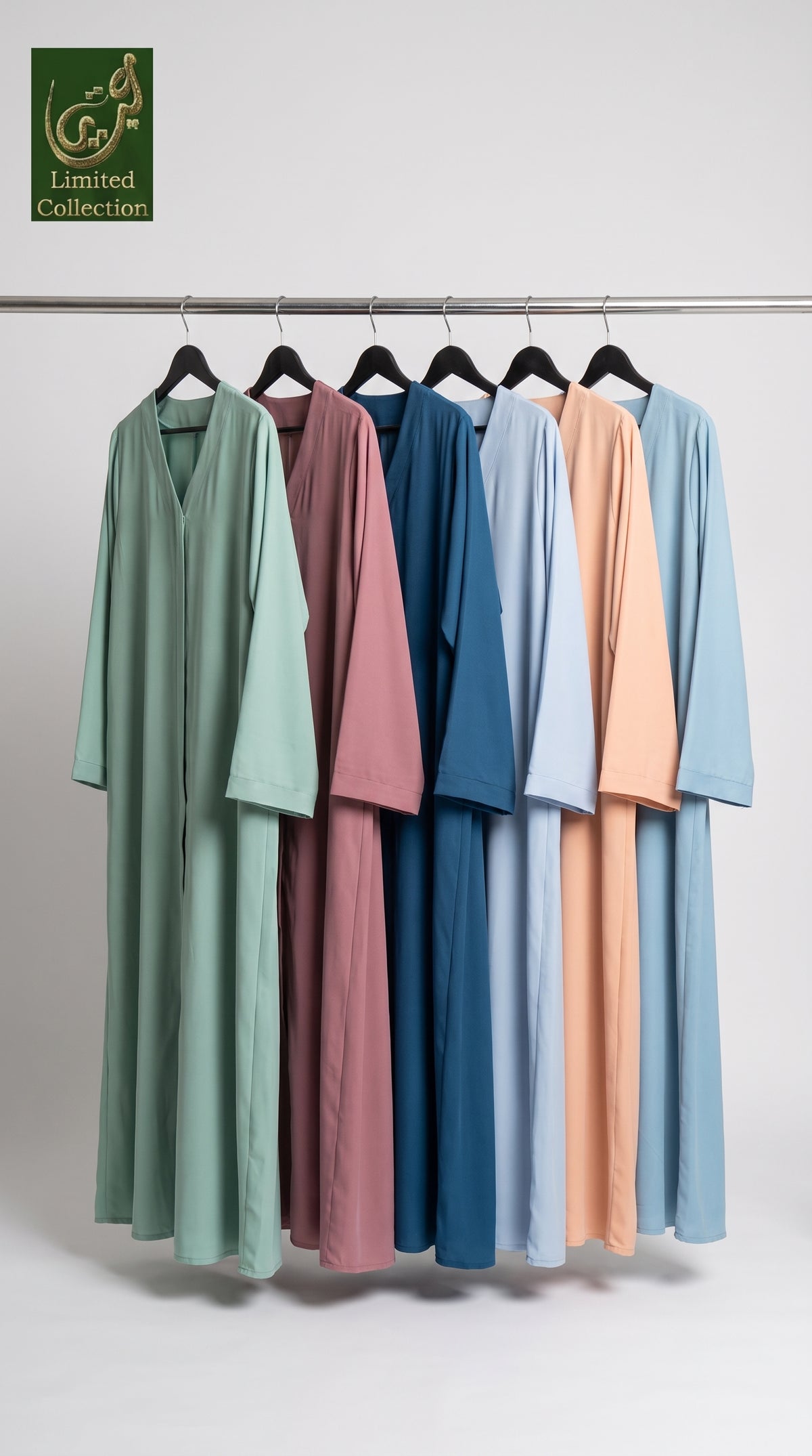Six long loose-fitting plain nida abayas hanging on black hangers from a metal rod, shown in mint green, dusty rose, dark blue, light blue, peach, and sky blue. A green 'Limited Collection' logo appears in the top-left corner against a plain light gray studio background.