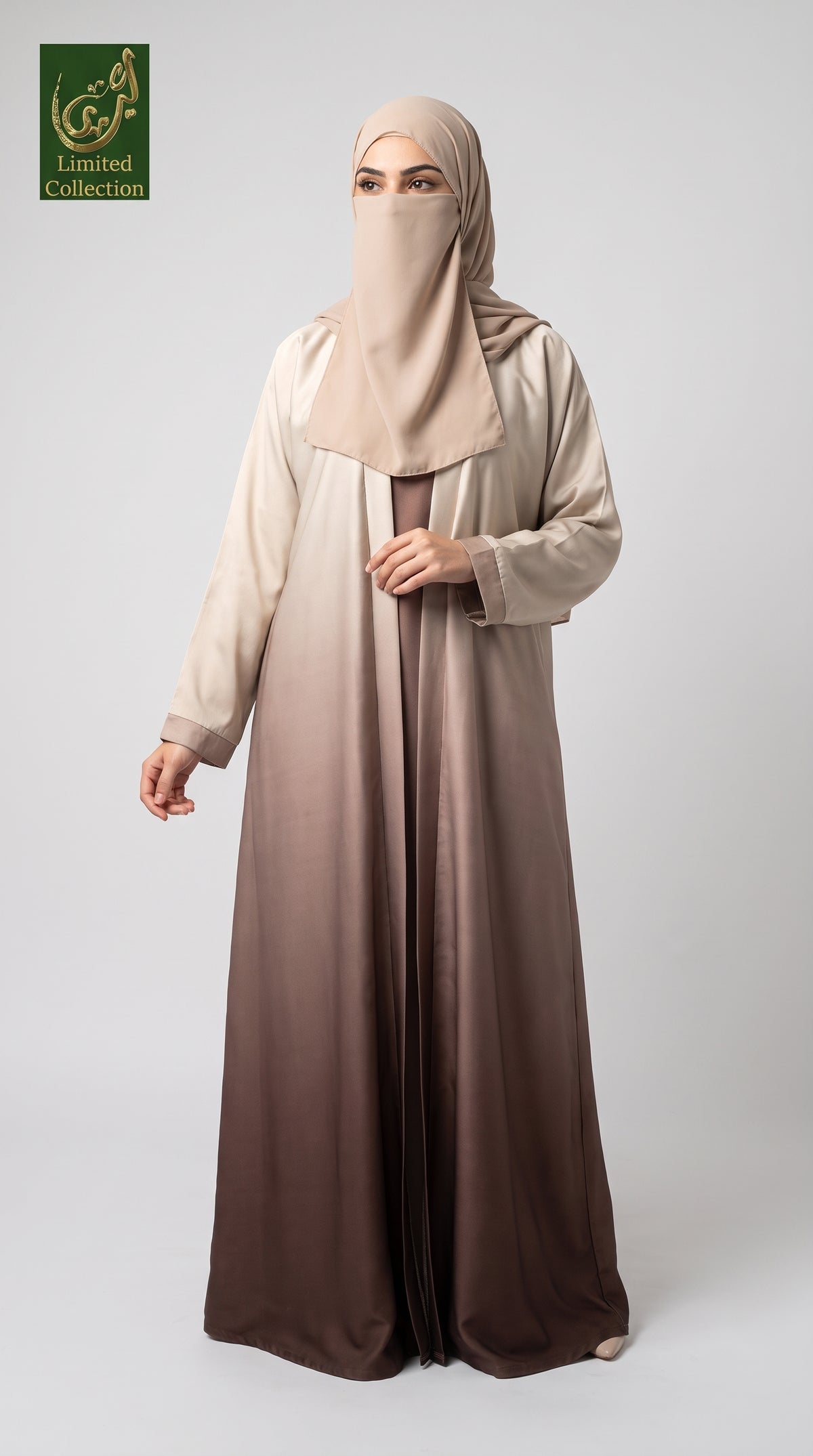 A woman modeling a modest long abaya dress with a matching hijab, featuring a smooth gradient from light beige at the top to deep brown at the bottom, set against a plain light gray background.