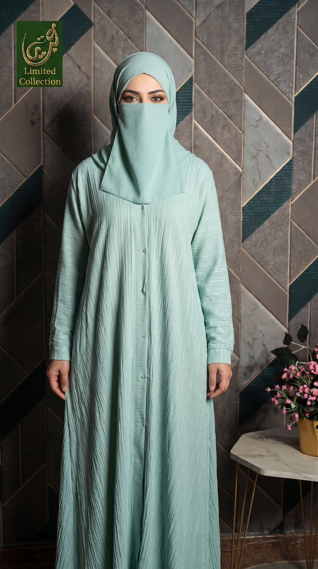 A woman wearing a light mint green long-sleeved abaya and matching hijab stands in front of a geometric tiled wall. The abaya has a subtle vertical crinkle texture and a buttoned front.