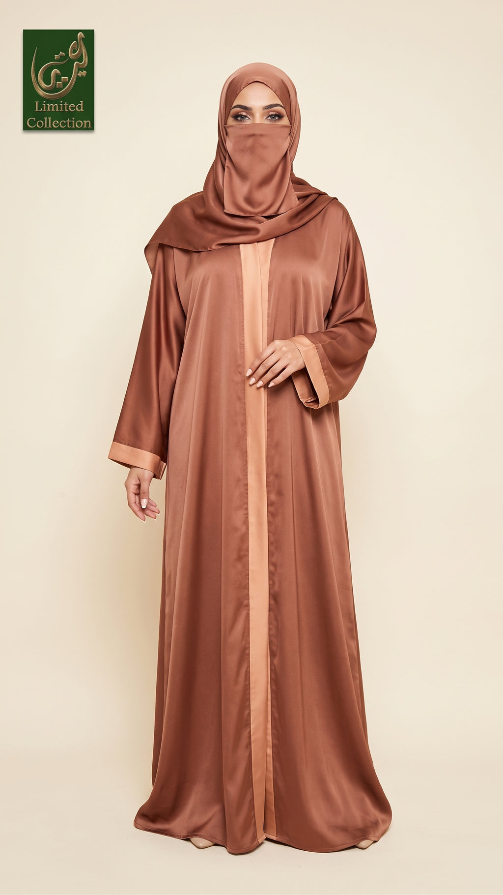 A woman modeling a long, flowing abaya in a warm rust-brown color with a matching hijab, standing against a solid light beige background. A green 'Limited Collection' logo is visible in the top-left corner.
