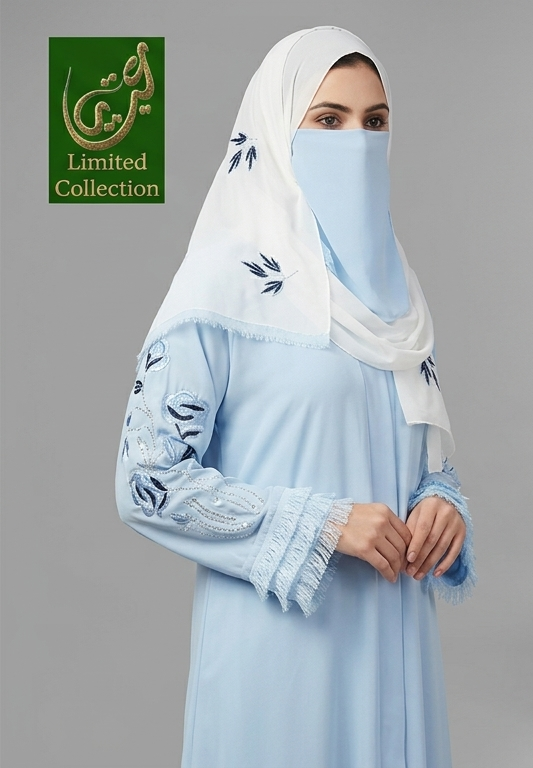 A woman wearing a light blue abaya with embroidered sleeves and a matching light blue face veil under a white hijab with blue embroidery. A green 'Limited Collection' logo is in the top-left corner against a gray studio background.