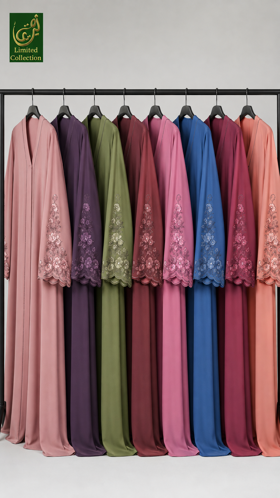 A set of long, flowing abaya dresses in multiple colors hanging on a black clothing rack against a light gray background. The dresses include shades of pink, purple, olive green, burgundy, blue, and peach, each with floral lace embroidery on the sleeves.