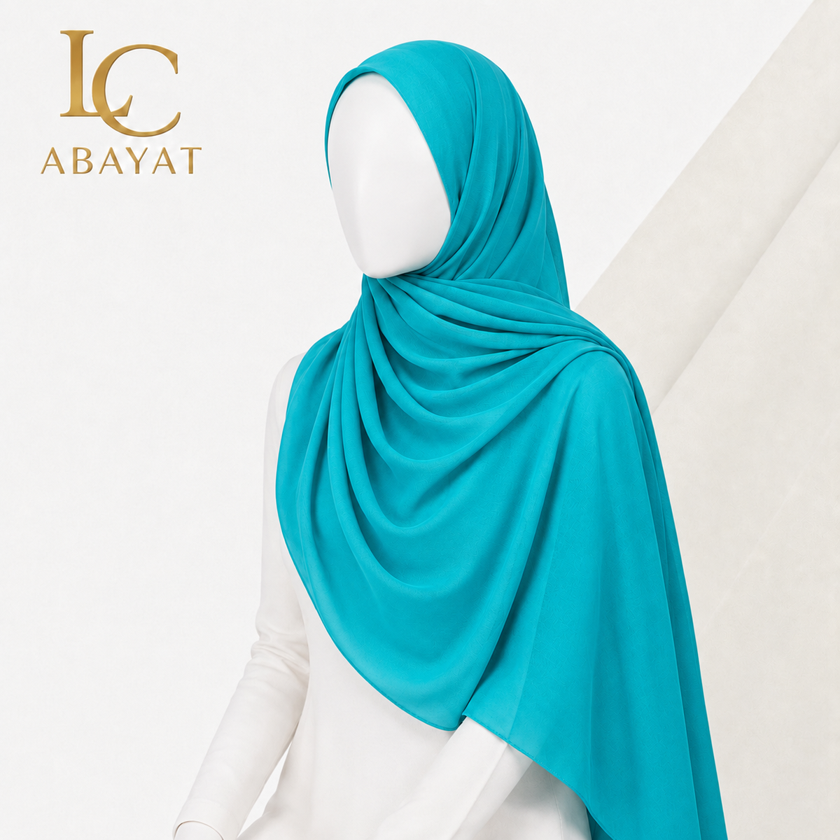 A turquoise blue hijab draped elegantly on a white mannequin, with the Abayat logo in gold in the top-left corner.