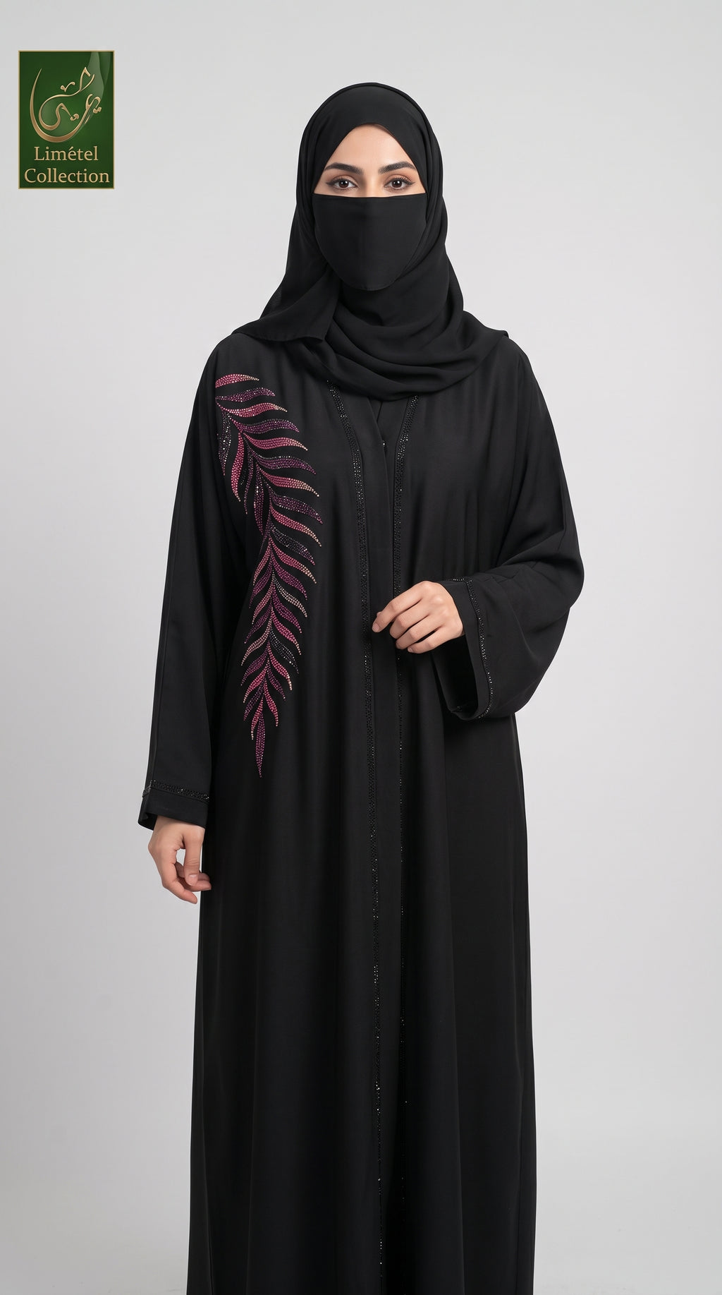 A woman wearing a black abaya with a pink embroidered leaf design on the sleeve, paired with a black hijab, standing against a light gray background. A 'Limfeet Collection' logo is visible in the top left corner.