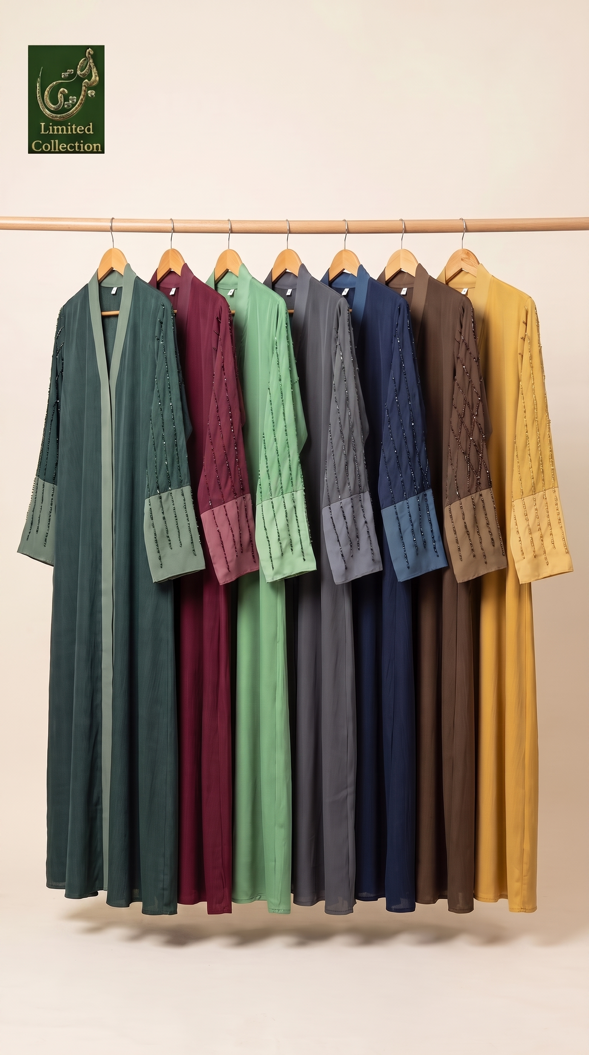 A set of seven long-sleeve, open-front handmade cutdana abayas in various colors (green, burgundy, mint, slate blue, navy, brown, and mustard yellow) hanging on a wooden rack against a plain beige wall. The 'Limited Collection' logo is visible in the top left corner.