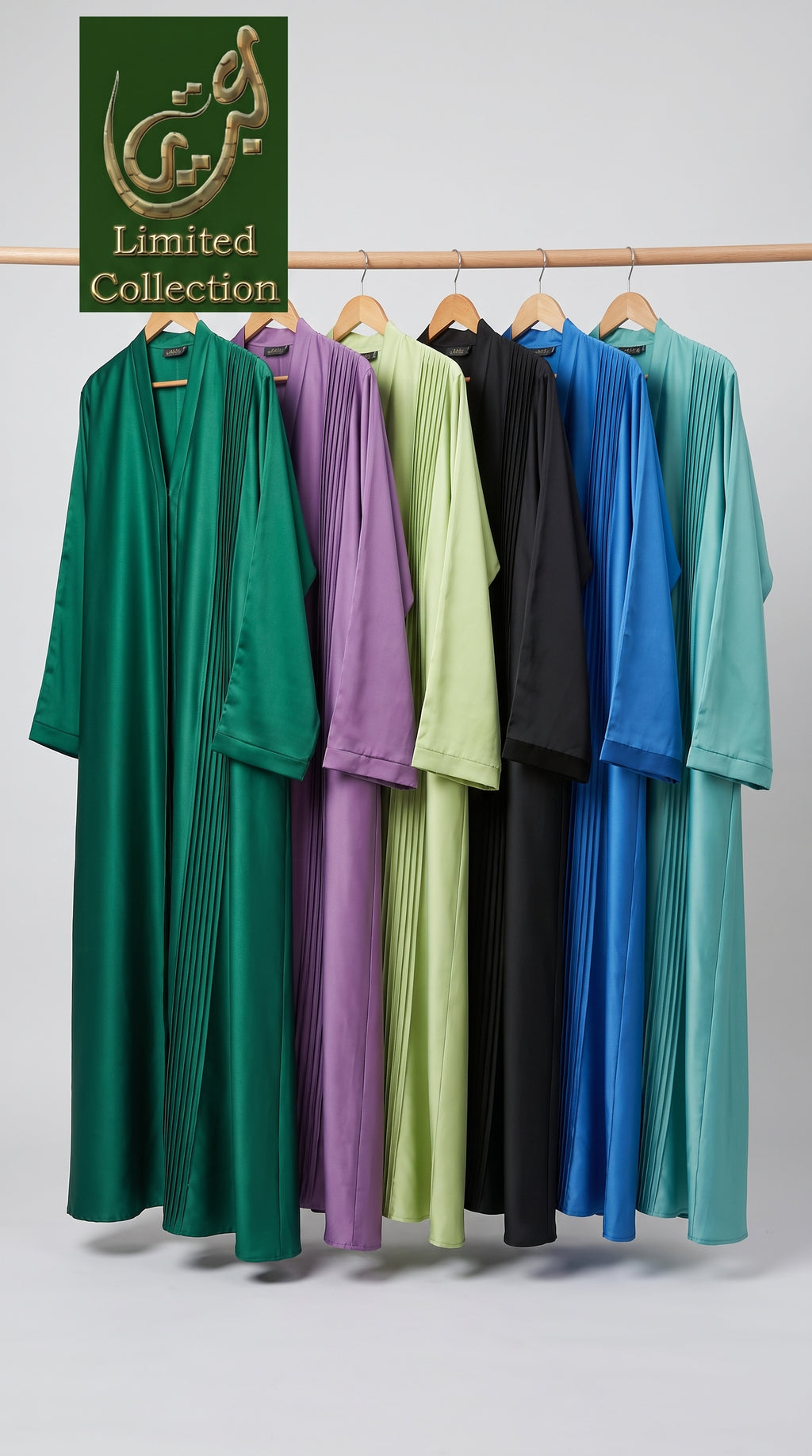 Six long flowing pleated abayas in green, purple, light green, black, royal blue, and teal hanging on a wooden rack against a light gray studio background. A green 'Limited Collection' logo badge appears in the top left corner.