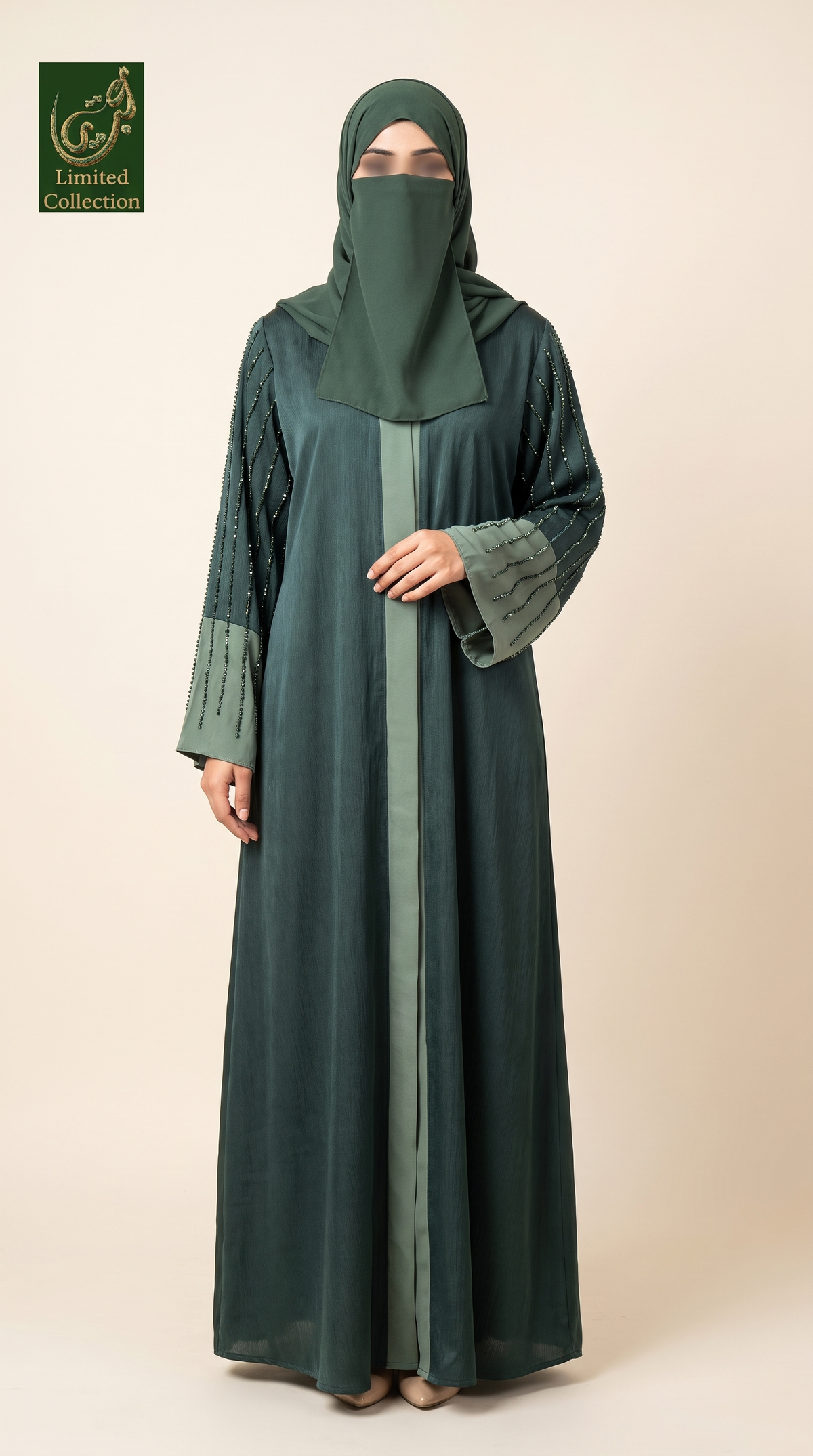 A woman modeling a dark green modest outfit with a matching hijab, featuring a long abaya with sheer patterned sleeves and a central panel, photographed against a plain beige studio background. A 'Limited Collection' logo is visible in the top-left corner.